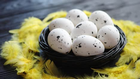 Whole-Chicken-eggs-in-a-nest-on-a-black-rustic-wooden-background--Pascua-symbols