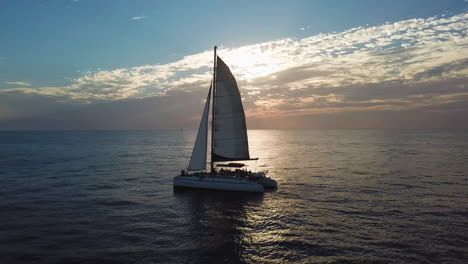 catamaran sailing at sunset