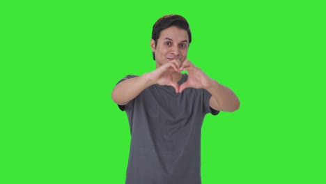 Happy-Indian-man-showing-heart-sign-Green-screen