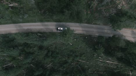 A-overhead-shot-of-a-camper-van-driving-down-a-dirt-road