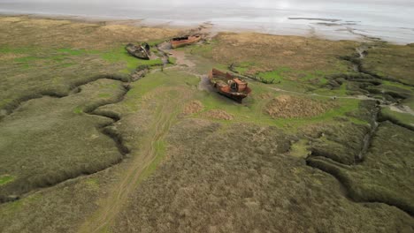 rusted shipwreck approach on salt marsh at fleetwood marshes nature reserve