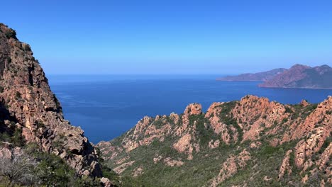 Panoramic-panning-view-of-Calanques-de-Piana-rock-formations-badlands-in-Corsica-island,-France