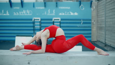 woman performing yoga split outdoors