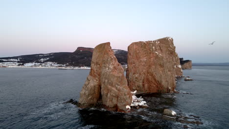 cinematic drone shot of famous perce rock in quebec, canada