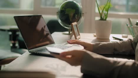 woman working on a laptop in a home office setting