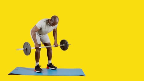 african man doing row exercises with a bar with weights