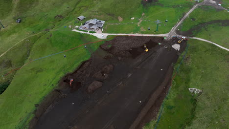 Construction-of-ski-slope-in-Dolomites-during-summer,-aerial-view