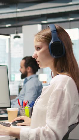 vertical video engineer coding with ai language model assistance in office, listening music