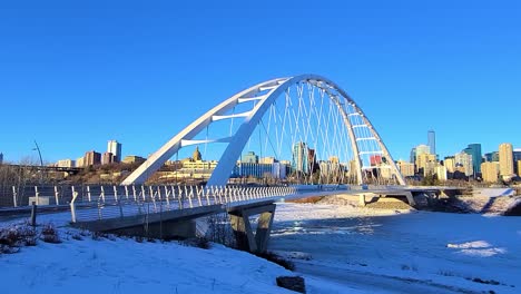 stunning twilight loop time lapse sunset post modern walter dale bridge winter sunny frozen north saskatchewan river family couple out for a walk on a clear blue skies sunshine lovely city skyline 1-4