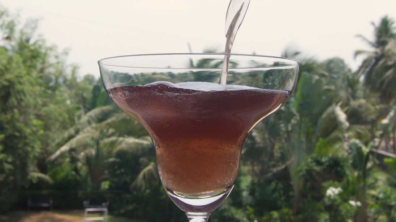 Pouring some red wine into the glass.