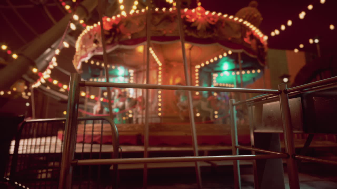 Empty amusement park at night with illuminated carousel and festive lights