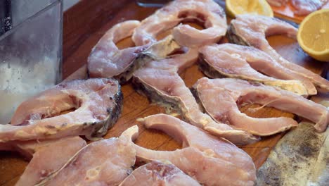 Static-close-up-shot-of-pieces-of-carp-being-salted,-Slovak-Christmas-Tradition