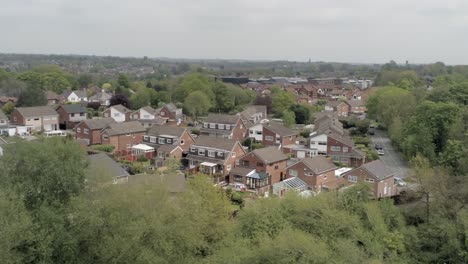 quiet british houses and gardens residential suburban property aerial view pan right wide