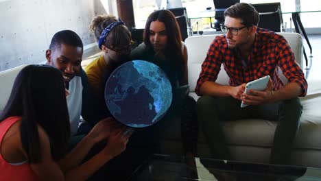 animation of globe over diverse group of business colleagues at meeting