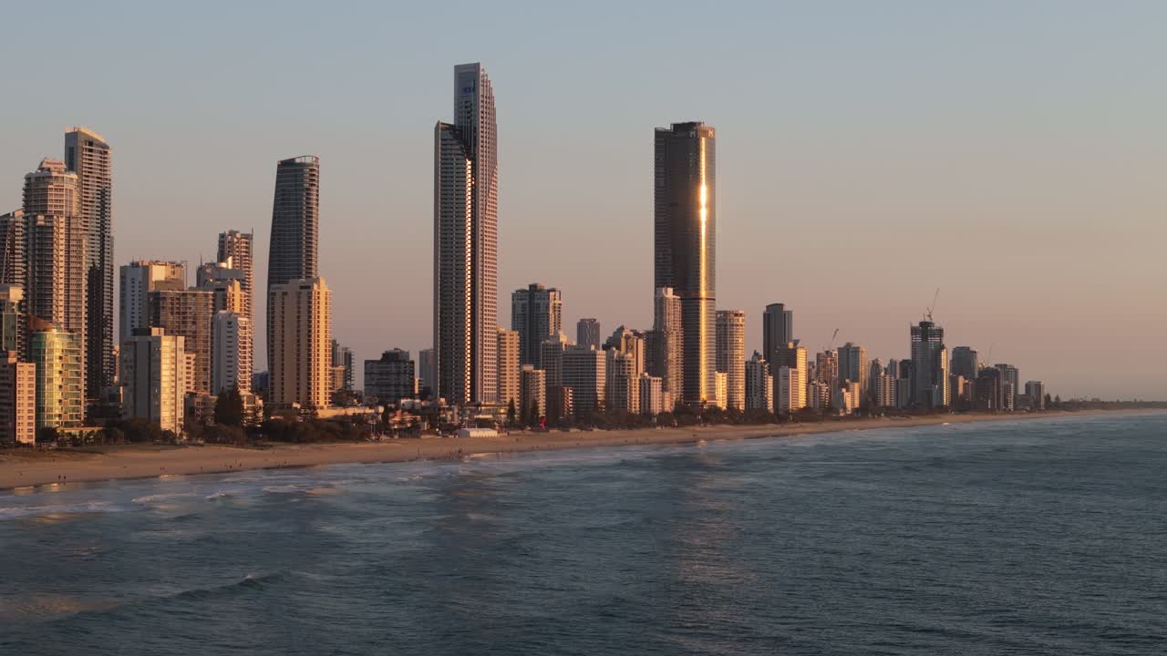 Sunrise along the beaches of Gold Coast, Queensland with sun reflecting across the water