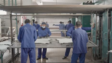 leather factory workers processing hides