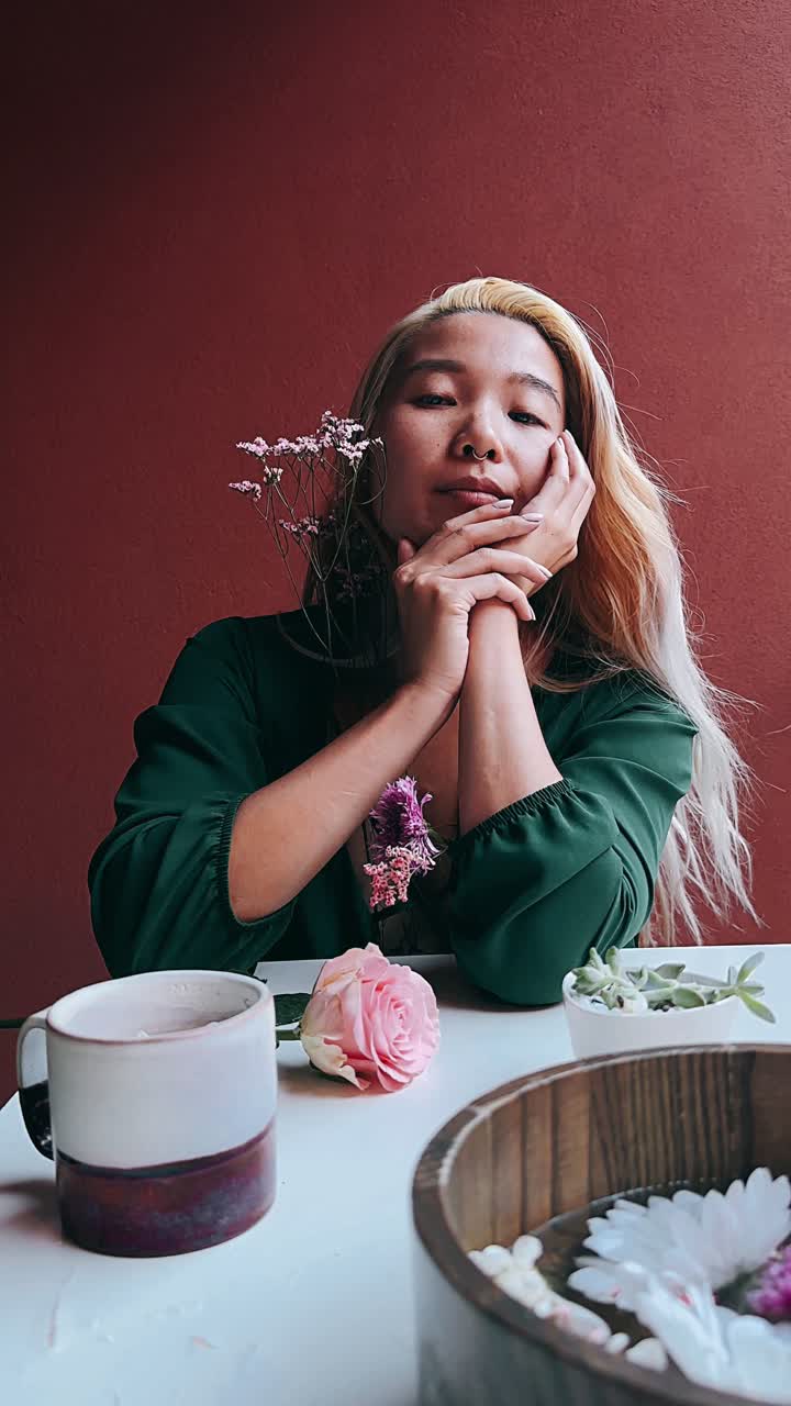 Woman Sitting with Flowers and Plants