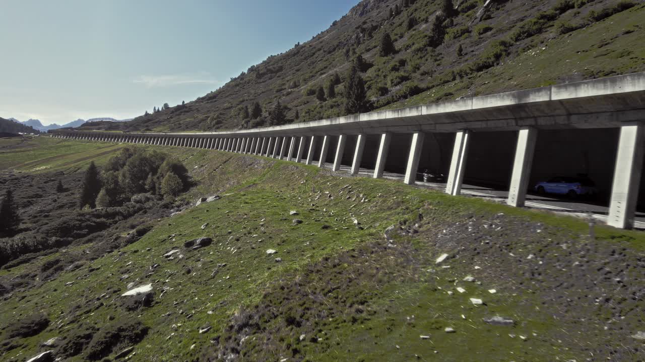 Aerial car driving in rock shed, beautiful calming mountain alps summer sunny landscape, K&uuml;htai, Austria