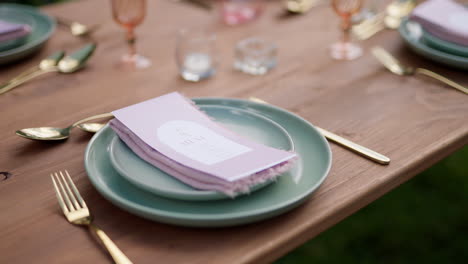 close up wedding reception table setup with plates and napkins, 4k slow motion