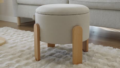 light gray storage ottoman with wooden legs