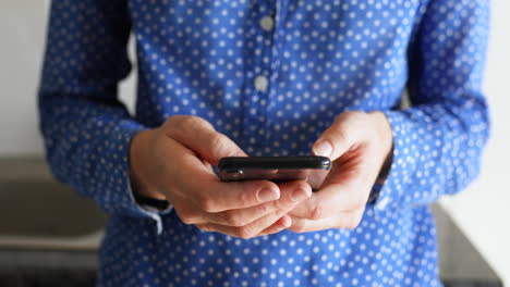 caucasian woman using her phone at home