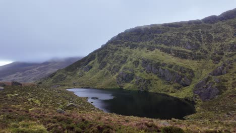 mountainside lake in the comeragh mountains waterford ireland on a cold rainy winter day