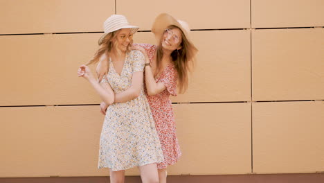 two young women friends posing outdoors