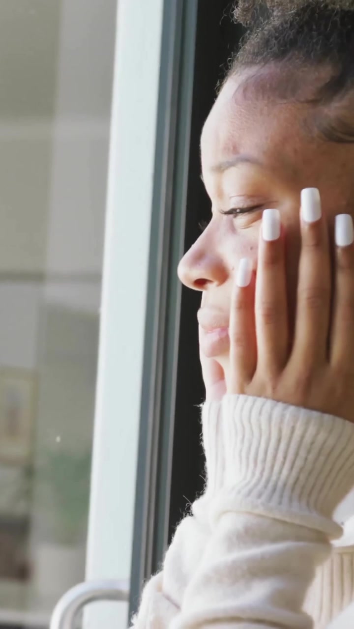 Looking out window, woman viewing animation of social media notifications
