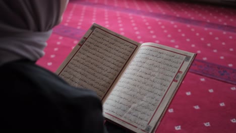 girl reading islamic holy book