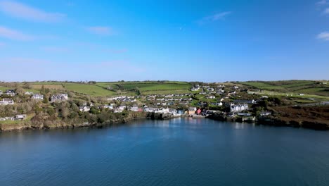 Wide-aerial-panorama-with-green-hills,-dotted-houses-and-old-fort---Charles-Fort-in-the-background-and-a-part-of-the-Castlepark-peninsula-in-Kinsale,-Ireland