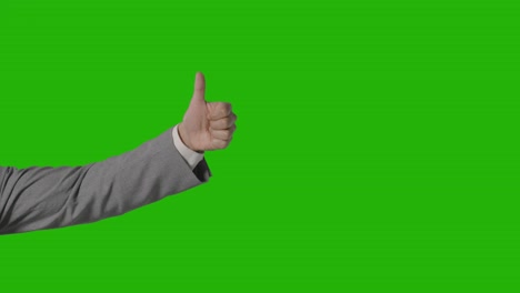 close up of arm of businessman in suit choosing between thumbs down and down gesture against green screen 1