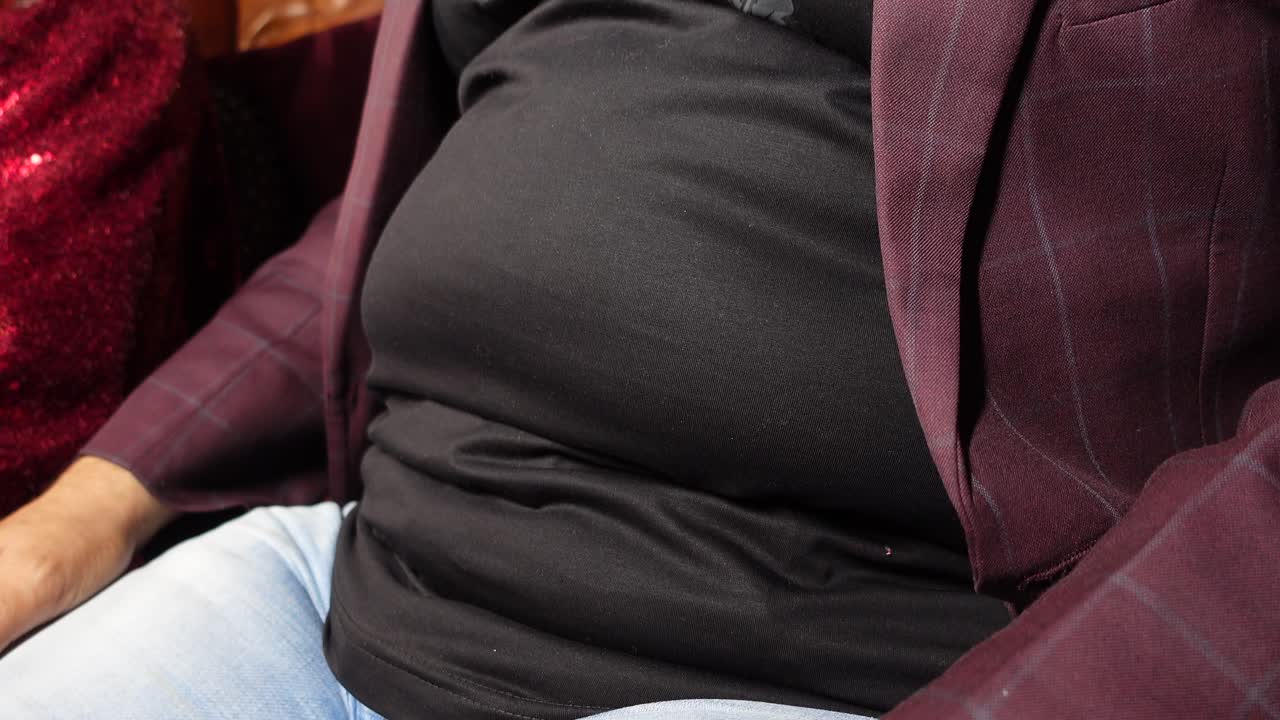 A person wearing a suit jacket and jeans