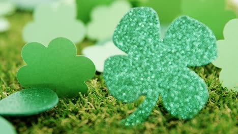 Close-up-view-of-sparkly-green-shamrock-on-grass-for-st-patricks-day