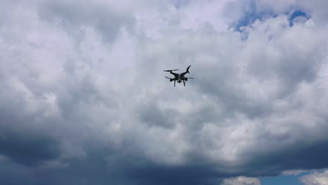 flying drone over fields. drone capturing aerial shots using camera against a blue sky
