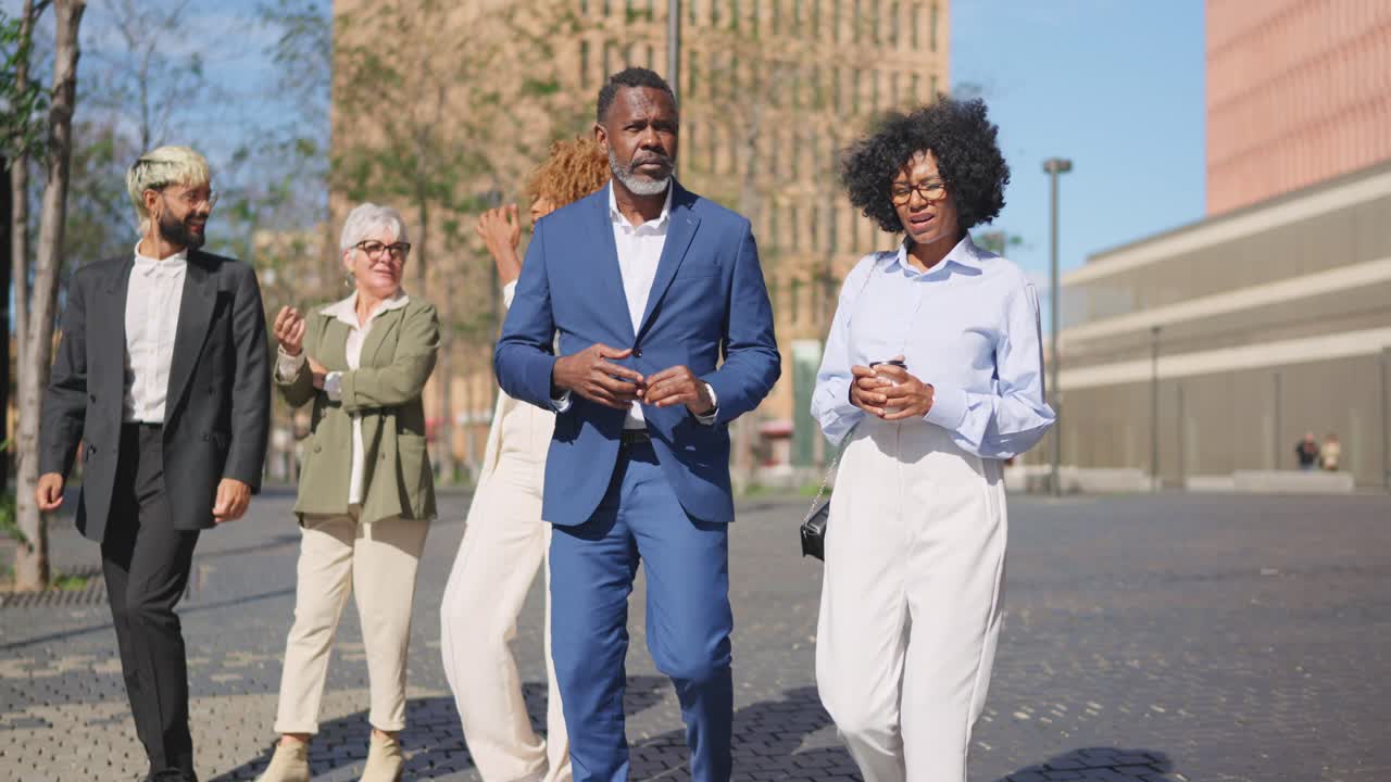 Businessman and businesswoman talking relaxed walking in the financial district