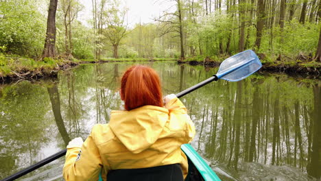 outdoor girl on travel tour paddle with kajak on river in spreewald