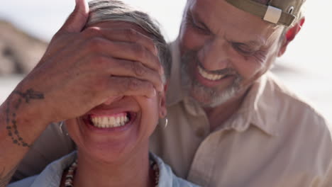 covering eyes, surprise and couple at beach