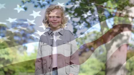 Animation-of-flag-of-america-over-smiling-caucasian-boy-standing-against-trees-in-park