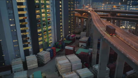 truck transporting goods, elevated logistics road, on top of hong kong container shipping yard, after dark, wide angle aerial follow shot, cinematic anamorphic look