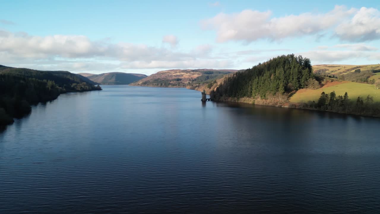 Lake Vyrnwy Straining Tower drone approach from far on a crisp, calm sunny winter afternoon - Wales, UK