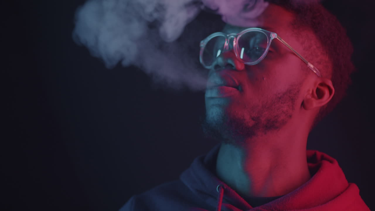 Man Vaping in Neon Light