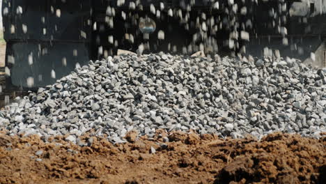 crushed stone crumbles to the ground from the truck body delivery of building materials  4k video