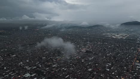 drone pierces low clouds over ecatepec's urban landscape