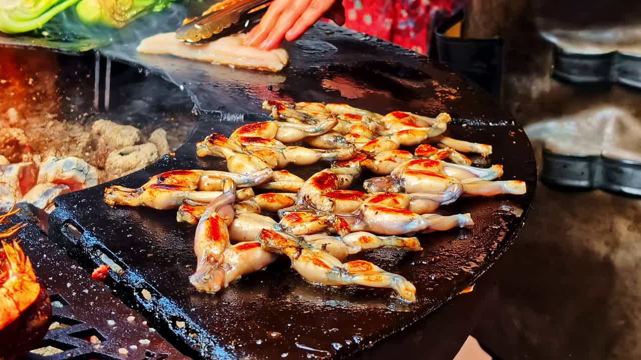 Outdoor cooking with fresh vegetables and shellfish on a grill