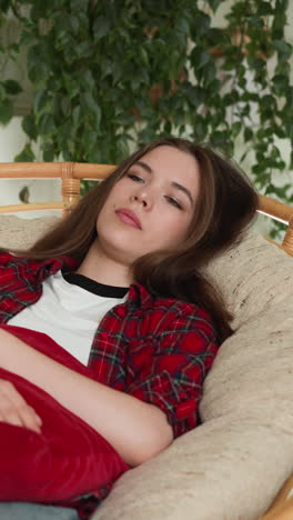 woman lies on chair with cushion napping . home chair becomes silent witness to emotional turmoil. woman haunted by memory of missed opportunity