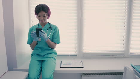 a beautiful young female nurse texting on her phone