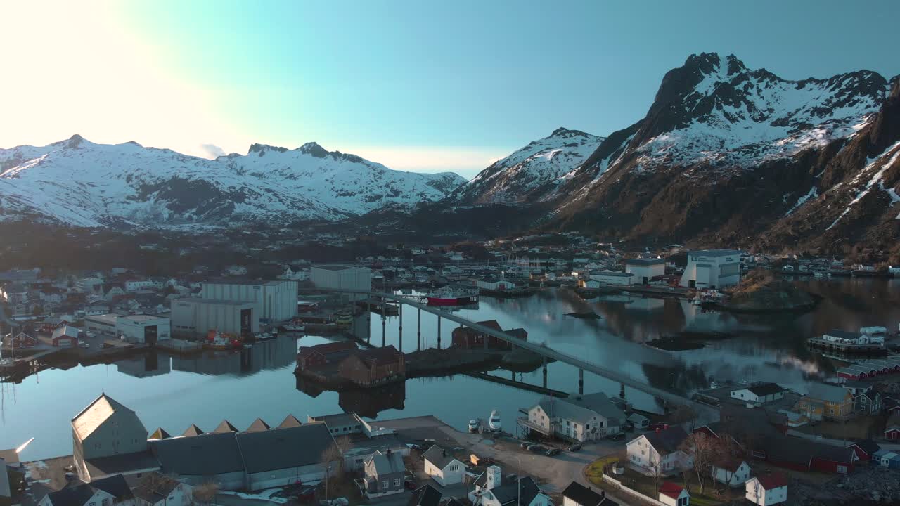 Aerial drone shot of the blue ocean in Lofoten, Norway also view of a small village