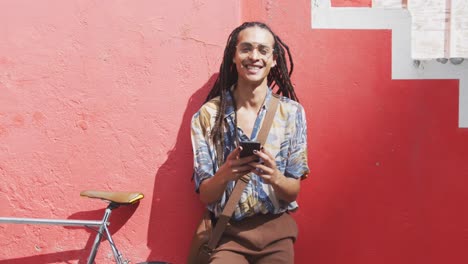mixed race man using his phone outside