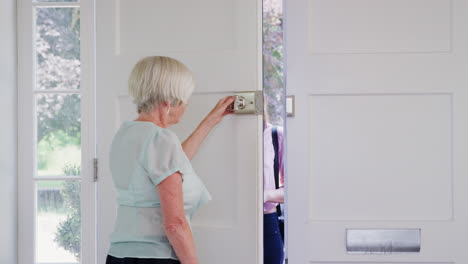 Senior-woman-greeting-female-care-worker-making-home-visit