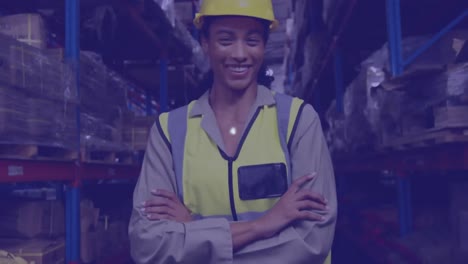 a young female warehouse worker smiling and looking directly at the camera